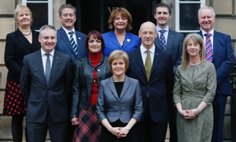Nicola Sturgeon stands in front of her new cabinet (Back row left to right) Roseanna Cunningham, Keith Brown, Fiona Hyslop, Michael Matheson, Alex Neil; (front row left to right) Richard Lochhead, Angela Constance, John Swinney and Shona Robison.