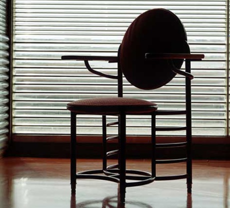 An office chair designed by Frank Lloyd Wright shown here with glass tube windows in Wright’s original buildings at SC Johnson headquarters.