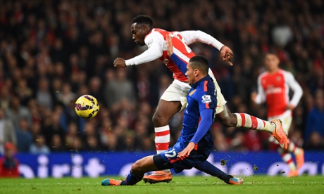 Danny Welbeck is cleanly tackled by Chris Smalling.