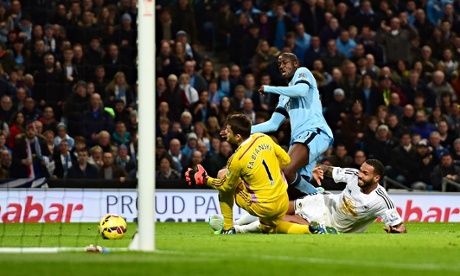 Yaya Touré scores Man City's second goal past Swansea's Lucasz Fabianski in the Premier League
