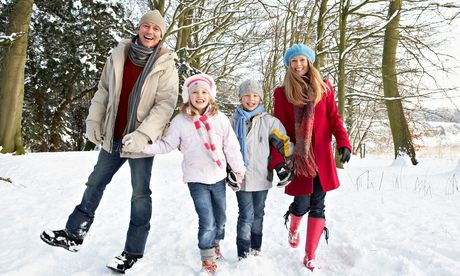 Family walking through snowy woodland
