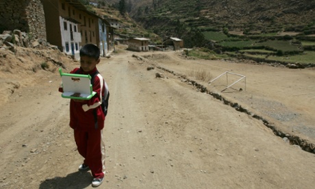 Kevin, 11, surfs the Internet on his laptop as he returns to his his home after school in Arahuay, an Andean hilltop village in Peru.