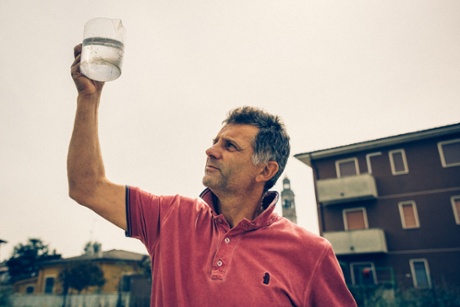 Mauro Busseti inspects water from the Montodine well. 