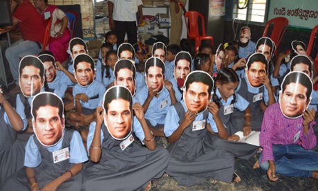 Pupils wear masks of Sachin Tendulkar at Puttamraju Kandrika village school in Nellore, Andhra Pradesh. He officially adopted the school.
