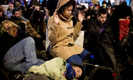 Protestors sit in silence for four and a half minutes while holding a spot in the streets of Capitol Hill in Seattle in response to the Ferguson grand jury decision not to indict police officer Darren Wilson in the death of Michael Brown, Monday, Nov. 24, 2014.