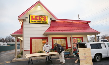 Workers board up a window of a restaurant after it was smashed when rioting erupted following the grand jury announcement in the Michael Brown case on November 25, 2014 in Ferguson, Missouri.