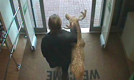 CCTV footage of man walking out of HomeSense in Taunton with reindeer ornament