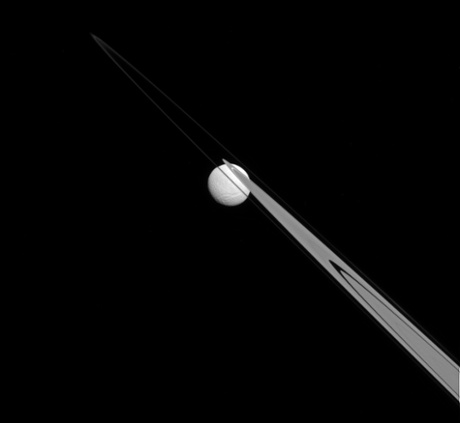 Like a drop of dew hanging on a leaf, Tethys appears to be stuck to the A and F Saturn's rings from this perspective.Tethys (1062 kilometres across), like the ring particles, is composed primarily of ice.