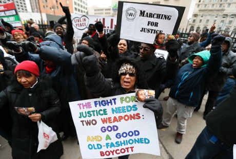 Renla Session, center, chants during a protest in Detroit Tuesday, Nov. 25, 2014.