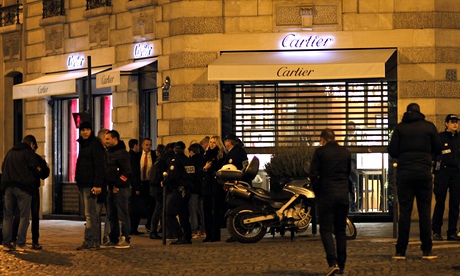 Police officers at the Cartier jewellery shop on the Champs Élysées in Paris. The robbers took their