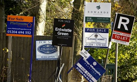 Estate agents' signs in Bolton. 'The housing market has come well off the boil,' said one economist.