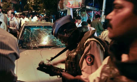 Policemen at the scene of a bomb blast in the Dadar financial district of Mumbai on 13 July 2011. Opera House and Zaveri Bazaar were also targetd in attacks which left a total of 26 people dead.
