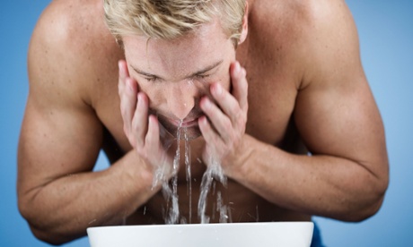 A man washes his face in gender-neutral water.