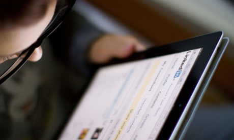 A young woman surfs LinkedIn on a tablet