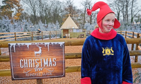 An elf watches that children are not injured at the reindeer enclosure.