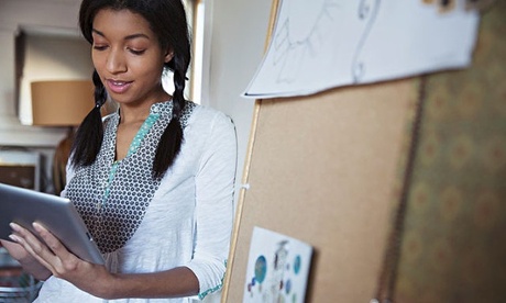 Female jewelry designer using digital tablet at workshop