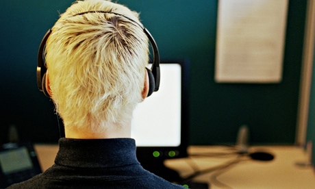 Man in call centre, wearing headset