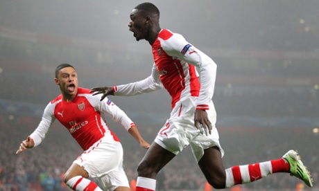 Sanogo celebrates with Arsenal's Alex Oxlade-Chamberlain.