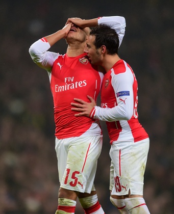 Arsenal's Alex Oxlade-Chamberlain is consoled by Santi Cazorla after missing a chance.