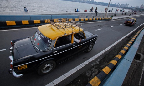 Local black-and-yellow taxis on Marine Drive, Mumbai.