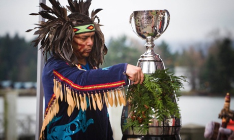 Alex Dan of the Musqueam first nation preforms a traditional blessing on the Grey Cup in Vancouver, British Columbia.