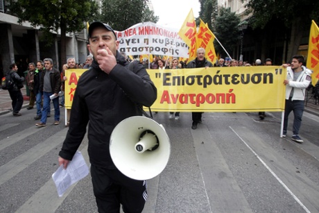 Protesters shout slogans as they march during a general strike in Athens, Greece, 27 November 2014.