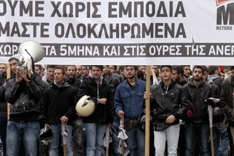 Protesters shout slogans as they march during a general strike in Athens, Greece.