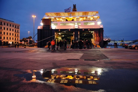 Unionists block the entrance of a docked ship at the port of Piraeus, near Athens during a 24-hour nationwide general strike, Thursday Nov. 27 2014