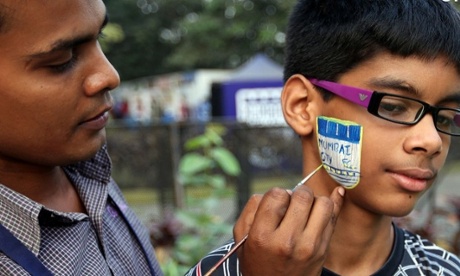 A young Mumbai City fan gets his face painted before the home game against Chennaiyin FC in the ISL.