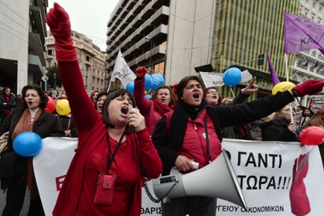 Employees march  in central Athens during a protest rally marking a 24-hour general strike on November 27, 2014.