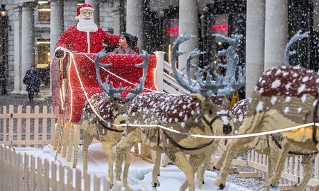 A boy sits with Lego Santa. Photograph: Jeff Moore for the Guardian