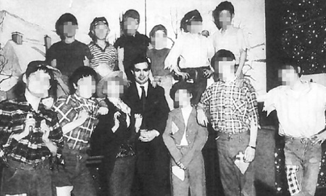 John Allen (centre) has his picture taken with children from his care homes.