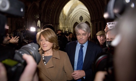 Andrew Mitchell and his wife Sharon walk away after the ruling was given in his case at the High Court
