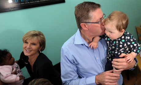 Denis Napthine kissing a baby, and Julie Bishop