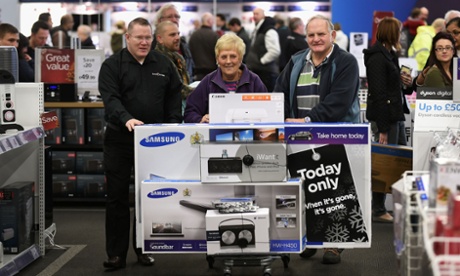Shoppers make their way to the checkout with a trolley full of goods at Currys PC World Megastore at Solihull Retail Park.