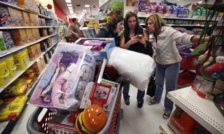 Target shoppers Kelly Foley, left, Debbie Winslow, center, and Ann Rich use a smartphone to look at a competitor's prices while shopping  shortly after midnight on Black Friday in South Portland, Maine.
