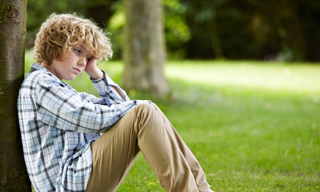 Sad Looking Boy Leaning Against Tree