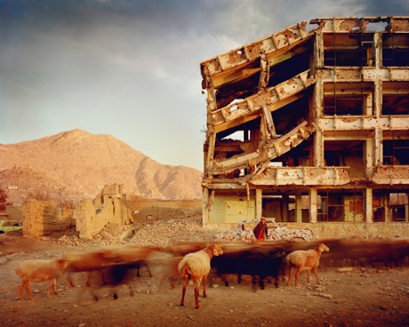 Bullet-scarred apartment building and shops in the Karte Char district of Kabul.