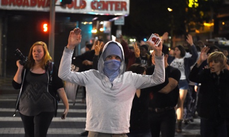 Protesters shout slogans as they march through downtown Los Angeles on November 26, 2014.