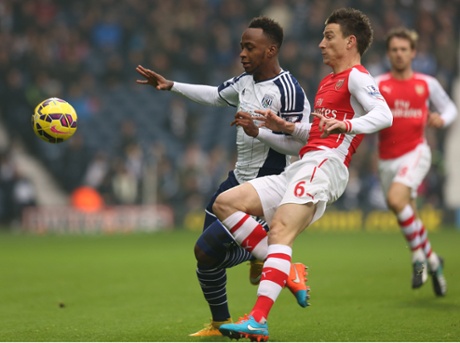 Saido Berahino vies for the ball with Laurent Koscielny.