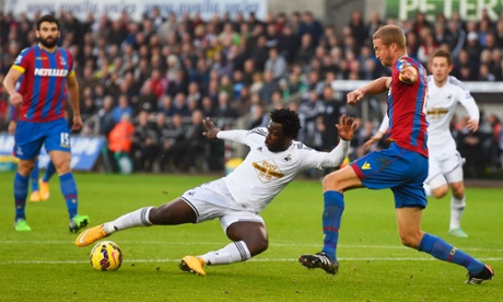 Wilfried Bony of Swansea City shoots past Brede Hangeland to score