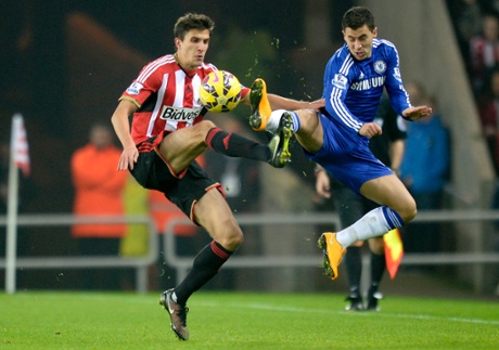 Santiago Vergini and Eden Hazard go in feet-first.