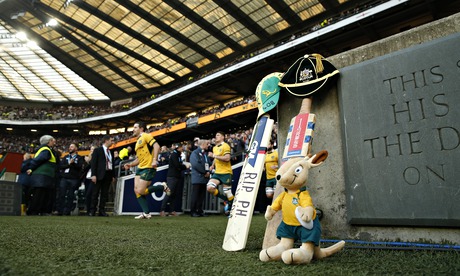 Cricket bats, Australian caps and a mascot are laid at the side of the pitch as a mark of respect.