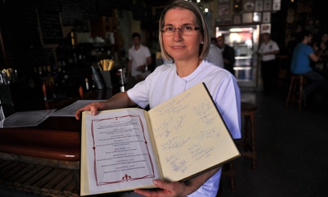 Restaurant owner Teresa Jiménez with her menu of dishes named after Game of Thrones characters. Photograph: Cristina Quicler/AFP/Getty Images