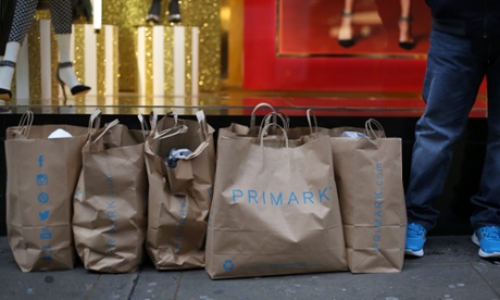 Customers wait with their purchases outside Primark's flagship store on Oxford Street.