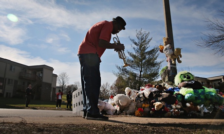 A man plays the trumpet at a memorial to Michael Brown in Ferguson, Missouri