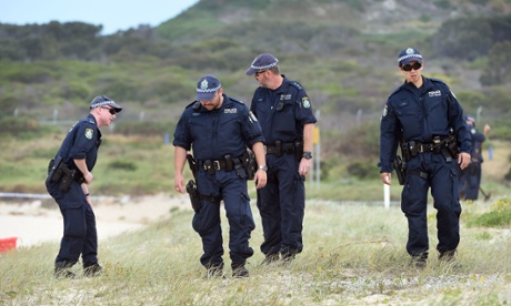 Police search the sand dunes at Maroubra after the discovery of the body.