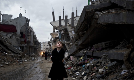 Palestinian boy in ruined part of Gaza