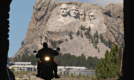 Motorcylist in front of the carved stone presidents of Mount Rushmore