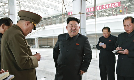 North Korean leader Kim Jong Un surrounded by officials taking notes